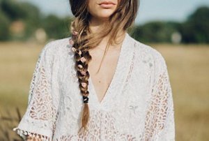 Woman with a long plait with flowers interwoven into it
