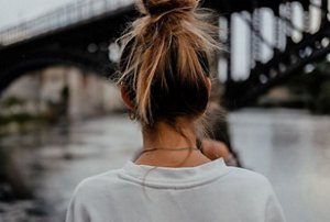 Woman wearing her hair in a top-knot style
