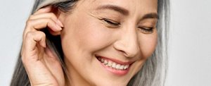 Smiling woman with natural, lustrous silver hair