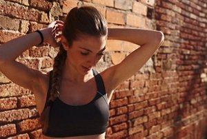 Woman working out outdoors with a long braided ponytail