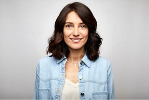 Smiling brunette woman wearing a denim shirt