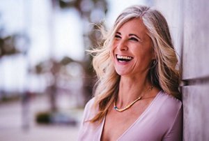 Smiling woman in her 40s with long, greyish blonde hair