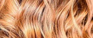 Close-up of shiny, healthy looking dark blonde hair