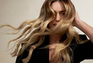 Woman with long, dark blonde wavy hair