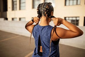 Woman washing her hair in the shower with a gentle shampoo
