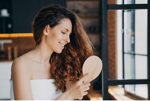 Woman brushing her hair after showering