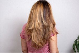 Expertly-balayaged hair with long butterfly cut layers