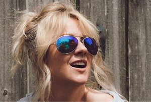 Smiling blonde woman wearing aviator sunglasses