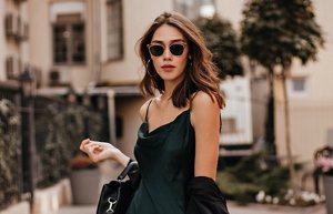 Young woman with chestnut brown hair styled in waves