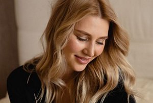 Smiling woman with her hair styled into long, beachy waves