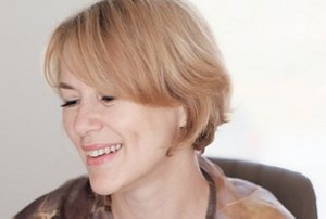 Smiling woman in her mid-50s with a short, volumised hairstyle