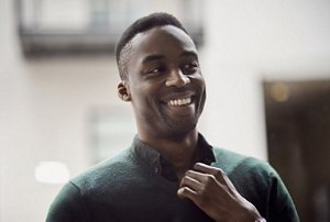 Smiling man with a taper fade hairstyle in a professional office environment