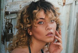 Woman with a mullet haircut with lowlights and highlights