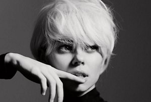 Woman with a 60s style pixie cut photographed in black and white