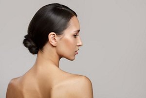 Woman with a neatly-styled low bun hairstyle