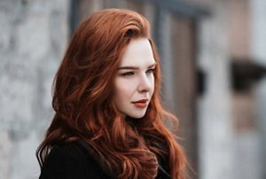 Woman with bright auburn hair