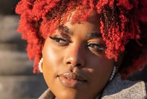 Black woman with dyed red hair