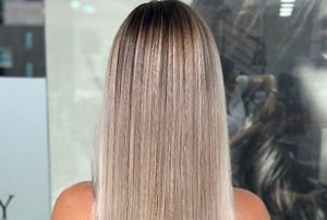 Blonde woman with a gentle, subtle root smudge