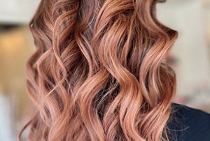 Light brunette hair with a soft rose gold tint