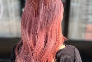 Woman with long, volumised rose gold hair