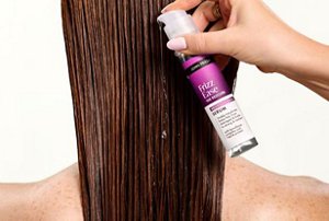Woman having John Frieda's serum applied to her damp hair