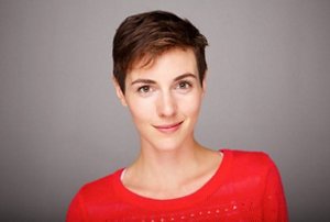 Smiling brunette woman with a short bobbed pixie cut