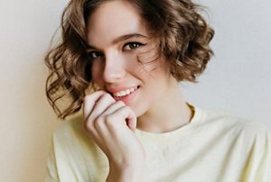 Smiling woman with an asymmetrical bob haircut