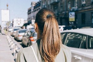 Brunette woman with long, straight hair in a neat ponytail