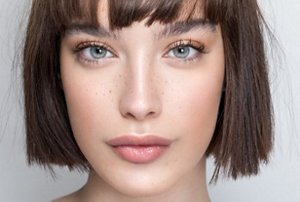 Woman with a chin-length bob with a blunt-cut fringe