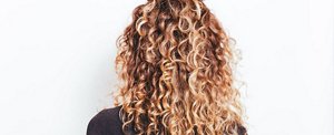 Woman with defined, healthy-looking long curly hair