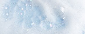Close-up of light blue foamy bubbles created by shampoo