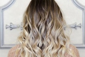 Woman with long, styled hair with dark bronde balayage