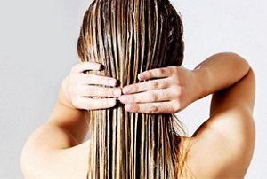 Woman hydrating her hair with a deep conditioning treatment