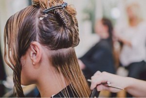 Woman having her hair trimmed at the hairdressers