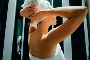 Woman drying her hair gently with a delicate, soft towel