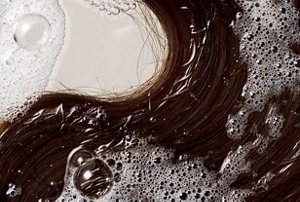 Close-up of wet, tangled brunette hair after being washed
