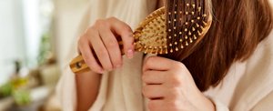 Woman running a hairbrush through her lengths