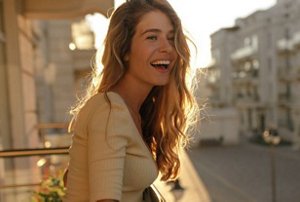 Smiling woman with her hair styled in long, flowing layers