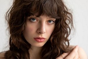 Woman with a shaggy long haircut with a styled fringe