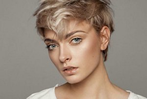 Woman with a triangular-shaped face with a pixie cut