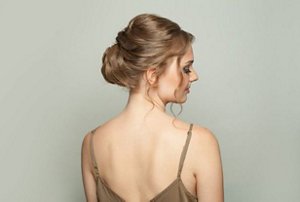 Elegantly-dressed woman with a single-strand updo hairstyle