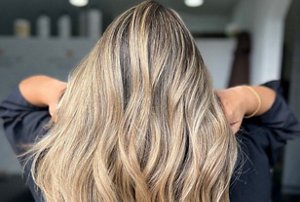 Woman showing off her soft brushed blonde hair