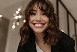 Smiling woman with a wolf cut hairstyle