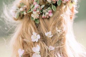 Wedding guest with an intricate plait hairstyle with flowers