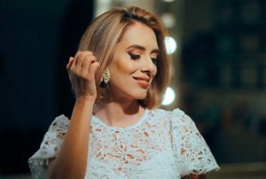 Happy woman with a long bob haircut dancing at a wedding reception