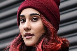 Woman with natural black hair cut into a neat bob
