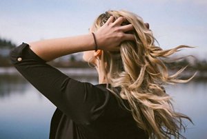 Woman with long blonde hair with ash and honey highlights
