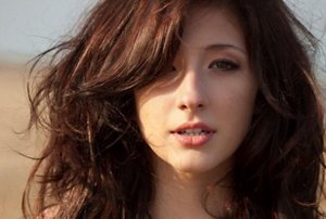 Young woman with a shaggy, windswept wolf cut