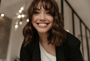 Smiling girl with a neatly-styled wolf cut