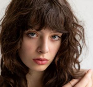 Brunette woman with a tousled wolf cut